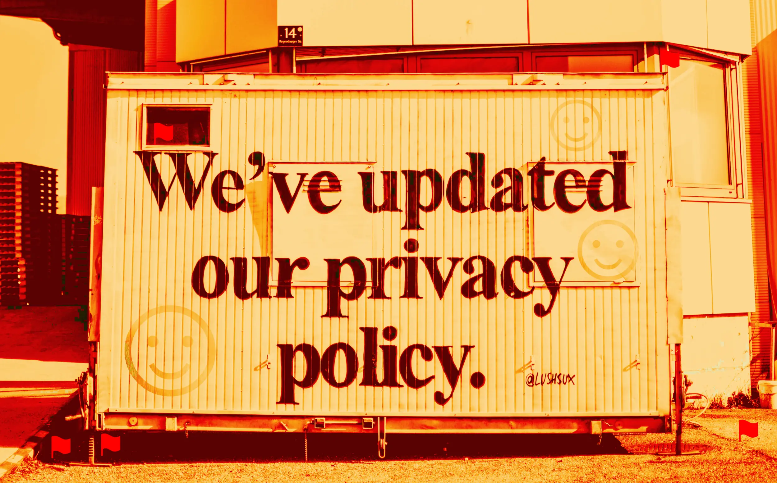 Filtered photo of a metal container left on the street, with on it the painted sentence "We've updated our privacy policy." with three faded happy face icons around it. On and around the container are icons of hidden red flags.